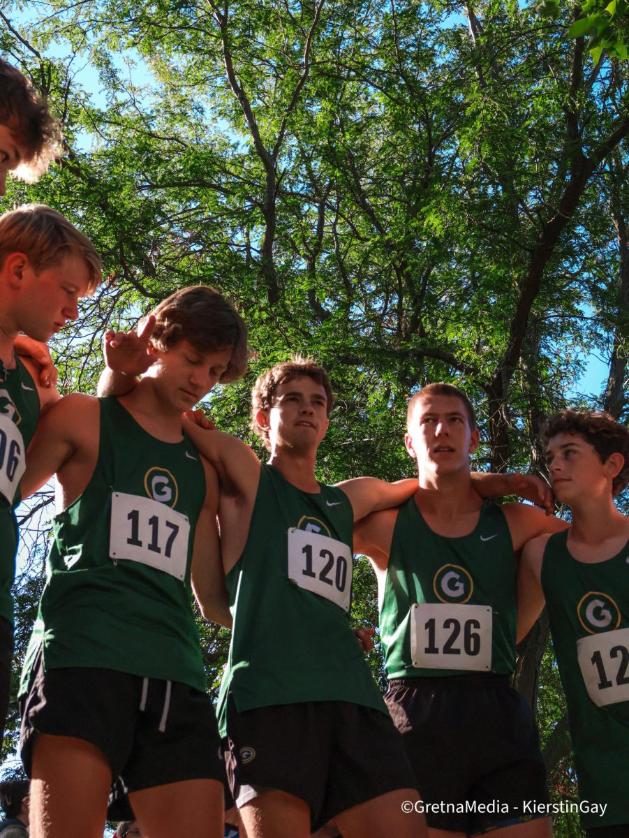 Senior Kieran Bear, sophomore Henry Matulka, senior Jaxon Nielsen, senior Colton Westra and freshman Benjamin Pierce huddle up before competing in the junior varsity section at the Burke Invitational on Sept. 7.