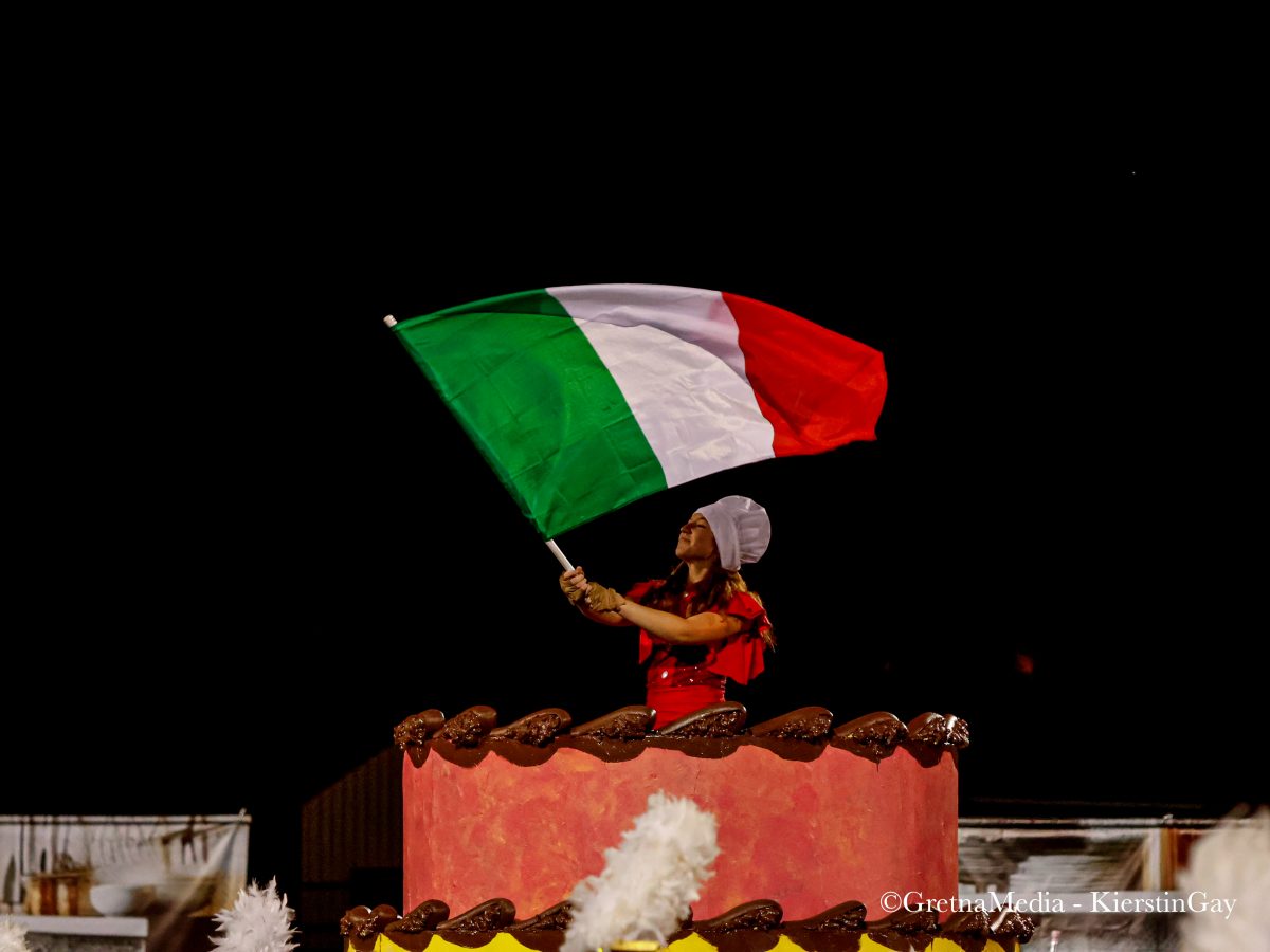 Freshman color guard member Chloe Germer waves her flag as the Gretna band performs their last performance of "Italiano" at the NSAA state marching band competition on Oct. 26.