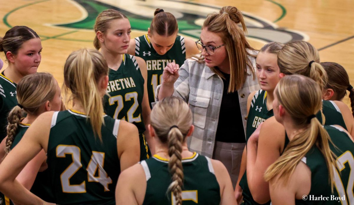 Head Coach Makayla Doggett makes a point during a time out when the girls basketball team played Skutt in December.  The Dragons are competing in Class B this season. 