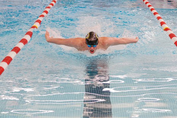 Senior Alex Hallgren makes his way toward the wall, cutting it close during his race on Saturday, January 11 at Millard South High School.