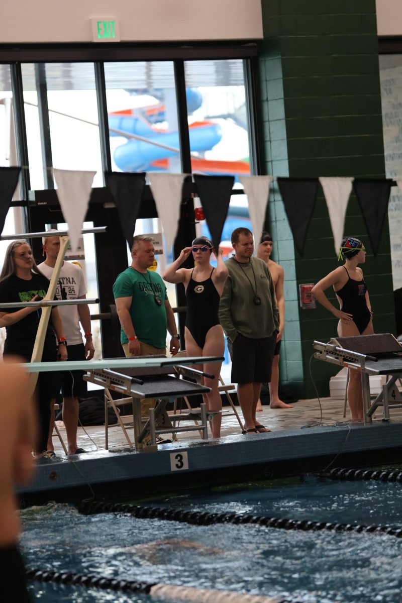 Lauren Von Seggern preps for her race, and adjusts her goggles.