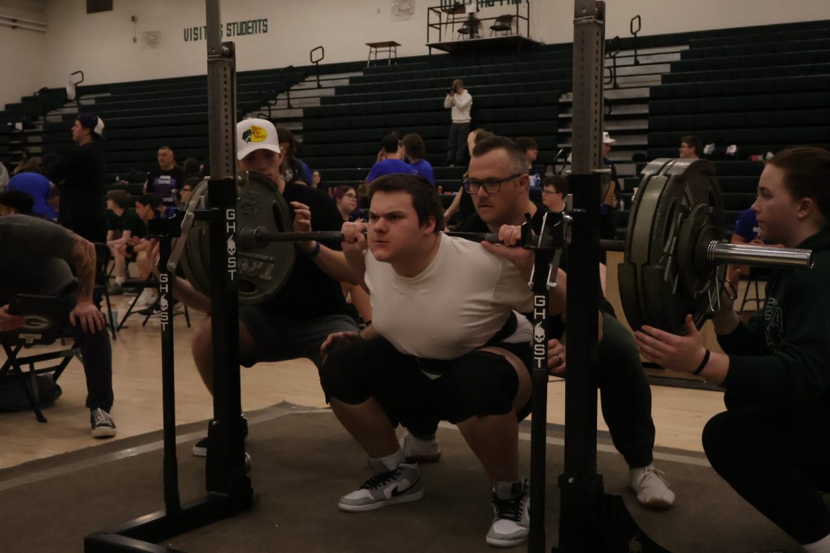 Sophomore Jacob Nielsen balances 325 pounds during his squat attempt in the main gym during Gretna's powerlifting meet. Nielsen placed second in his weight class.