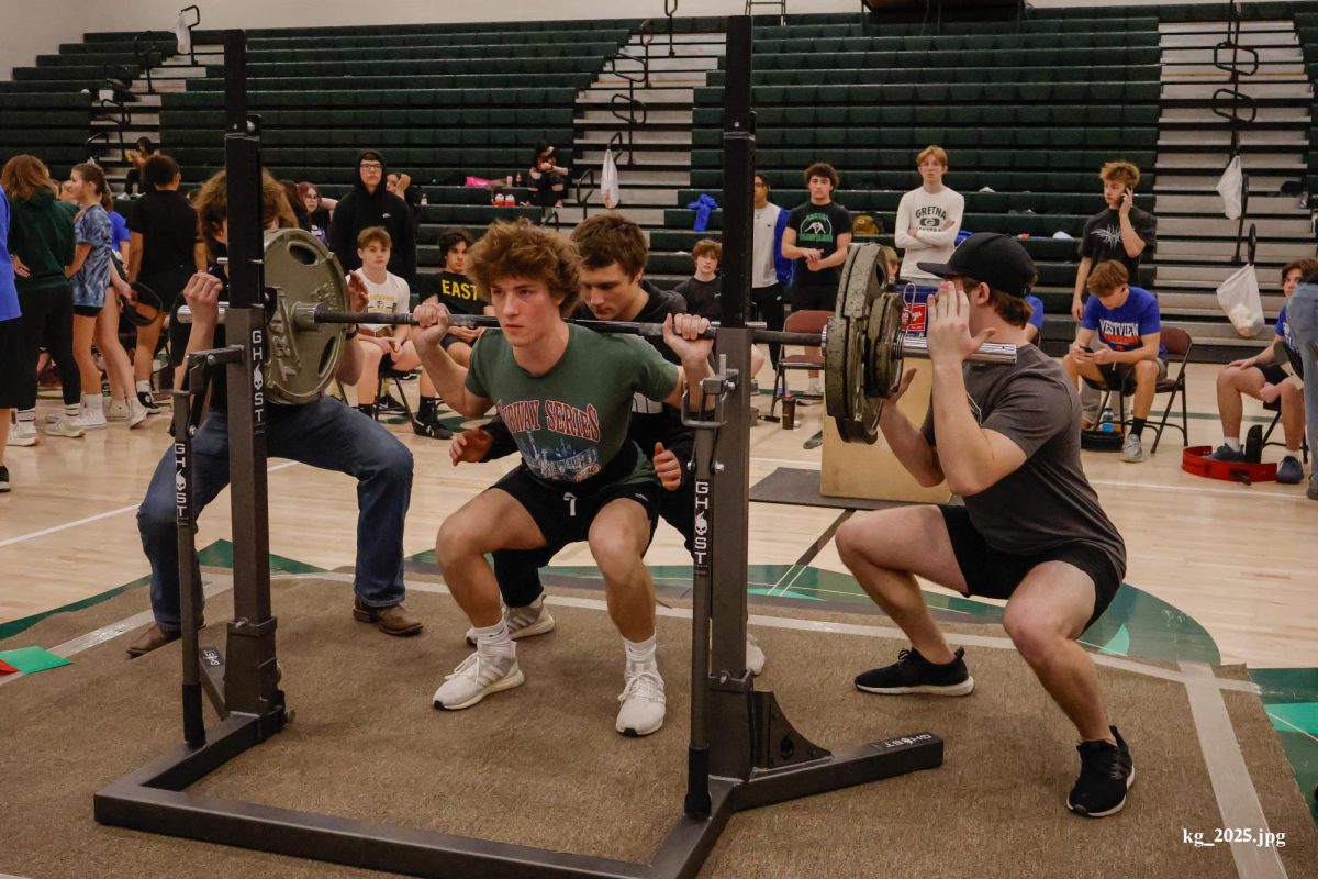 Sophomore Elliot Willnerd squats 265 pounds in his second attempt of the meet. Willnerd placed second in his weight class.