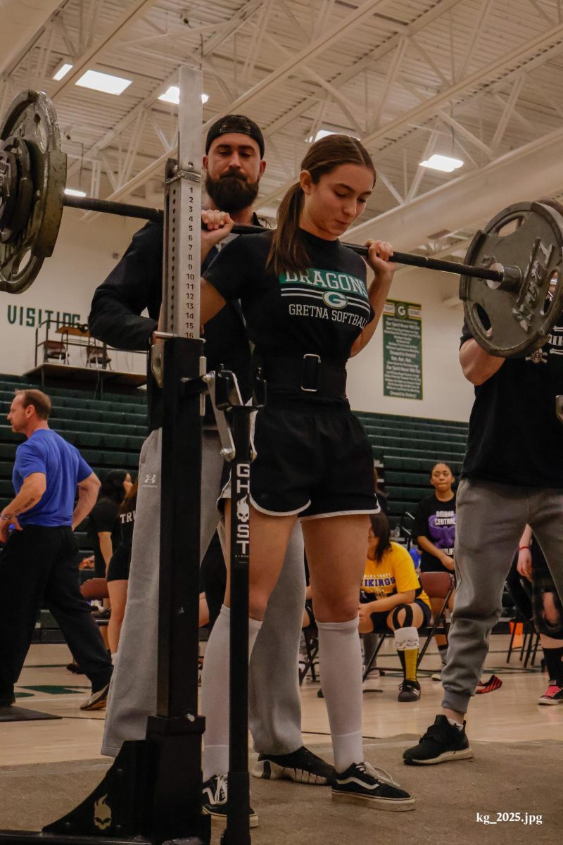 Junior Jayden Prososki takes a deep breath before attempting one of her three lifts in the squat category in the main gym during GHS's second annual meet on Feb. 8.