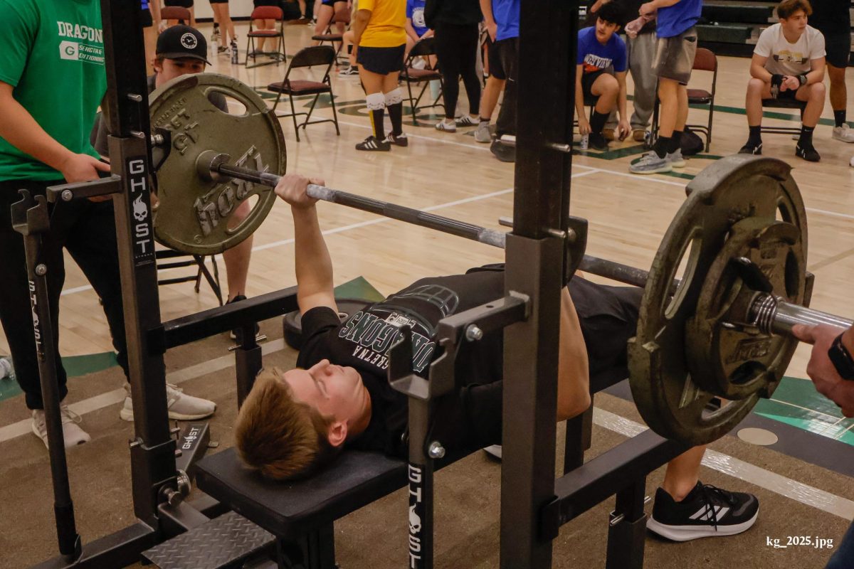 Sophomore Maycen Walters pushes through pain as he presses against the bar during his bench press attempt at the GHS meet.