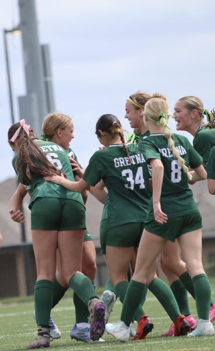 The Gretna Girls Soccer Team celebrates after making a goal. 