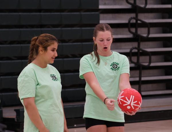 Senior Molly Robledo demonstrates to Nadia Yousufzai how to serve the ball at last year's Special Olympics volleyball tournament. Robledo has volunteered daily in the ACC room for years. 