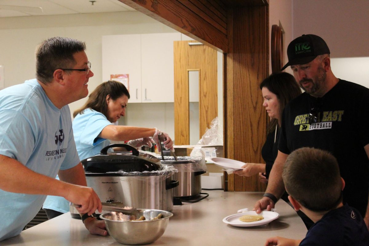 Resurrection Evangelical Lutheran Church members help dish out pancakes and sausage to Gretna residents on Saturday morning, July 26.