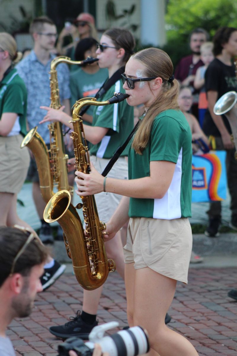 A GHS student plays the saxophone as a part her high school's marching band performance during Gretna Day's Grand Parade on July 26.