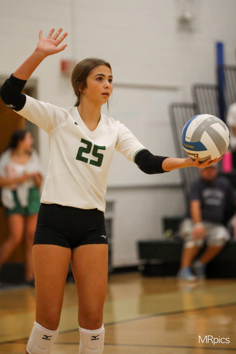 Freshman Caroline Dodson goes to serve to various reserve and JV 2 players during the Gretna volleyball scrimmage on Aug. 22.