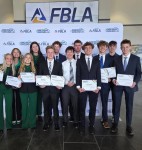 Senior Caleb Haecker (First row, third from the left) holds his awards at the state FBLA competition in Kearney from last spring. “I can always count on him (Caleb) to pitch in, to do the things that we do in the club with volunteering for activities," said Christine Swantek, FBLA sponsor. "He’s always available, saying, ‘Yep, I’m available. I can help out.”’
