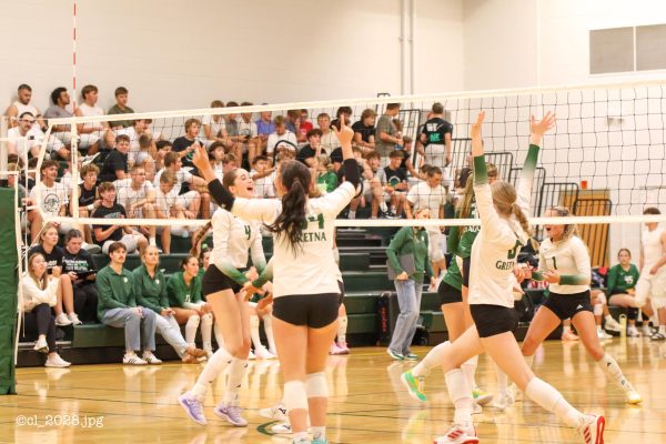 Gretna's JV volleyball team celebrates getting a point.