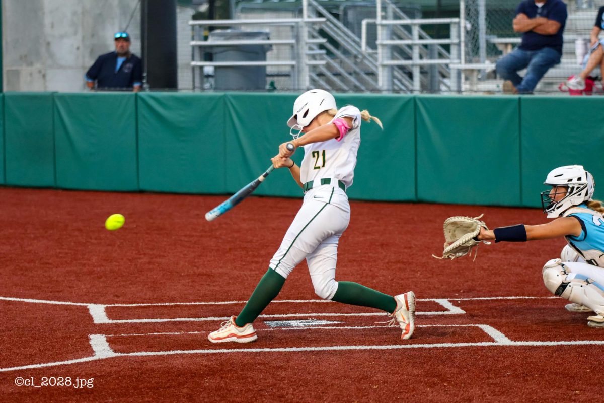 Senior Emerson Boyer makes contact and hits a ground ball to left side of the infield on Sept. 22.