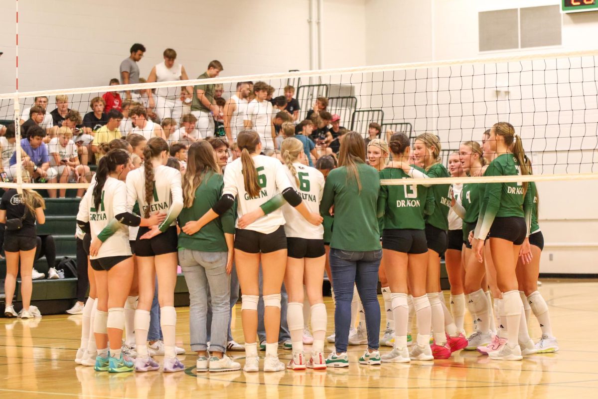 The varsity and JV squads gather at the end of their Extravaganza scrimmage last month. Coach Wendy Loberg has big goals for the team this season.