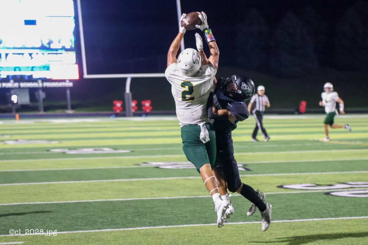 Junior Talon Daharsh climbs the ladder against a Elkhorn North to make a crazy catch to extend Grtena's drive down the field.