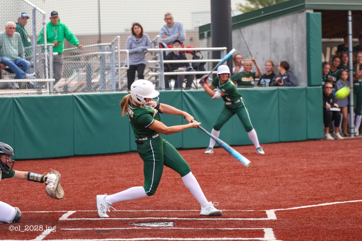 Senior Emerson Johnson swings for the fences and crushes a home run against Rock Bridge as Gretna tied the game in the first inning.