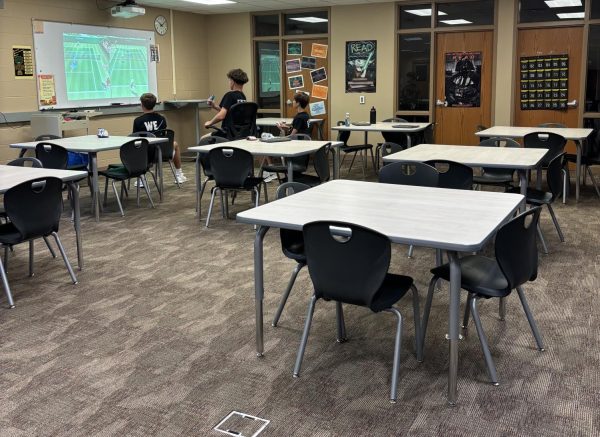 During a study hall, three freshmen, are hanging out in the library playing a game.  