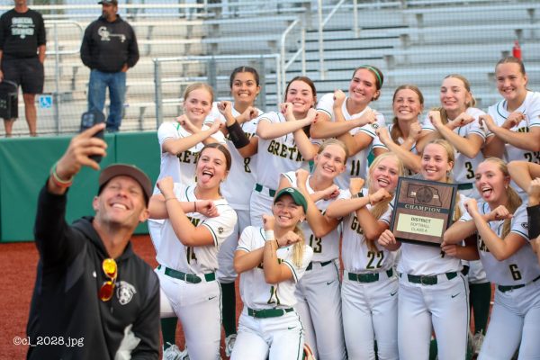Gretna's Activities Director Matt Curtis poses for a selfie with the softball team as they won District in front of the home crowd on Oct. 9.