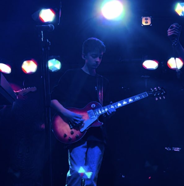 Freshman Owen Rist holding his guitar, at The School of Rock performance. Photo courtesy of Owen Rist.