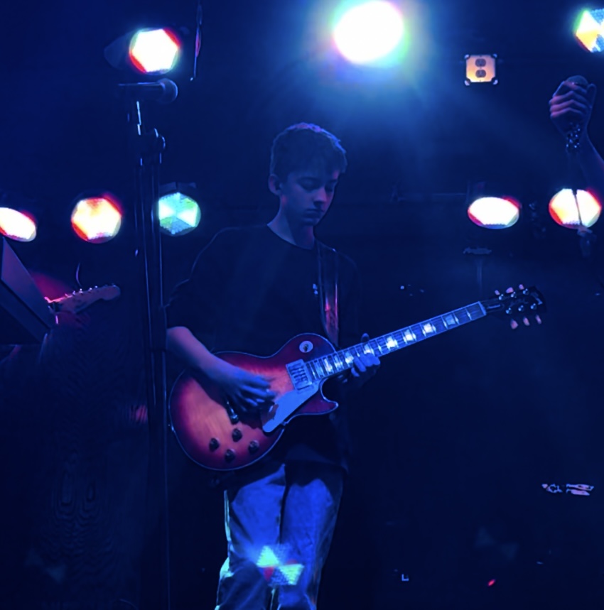 Freshman Owen Rist holding his guitar, at The School of Rock performance. Photo courtesy of Owen Rist.