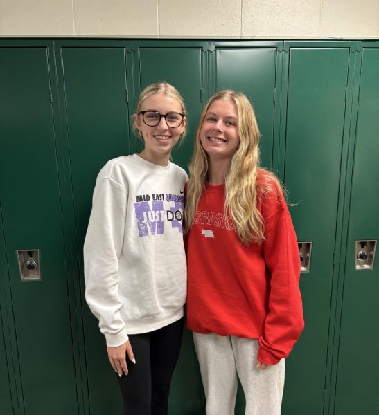 Senior Avery Hansen and freshman Ella Hansen smile because they get to be in with each other at school.