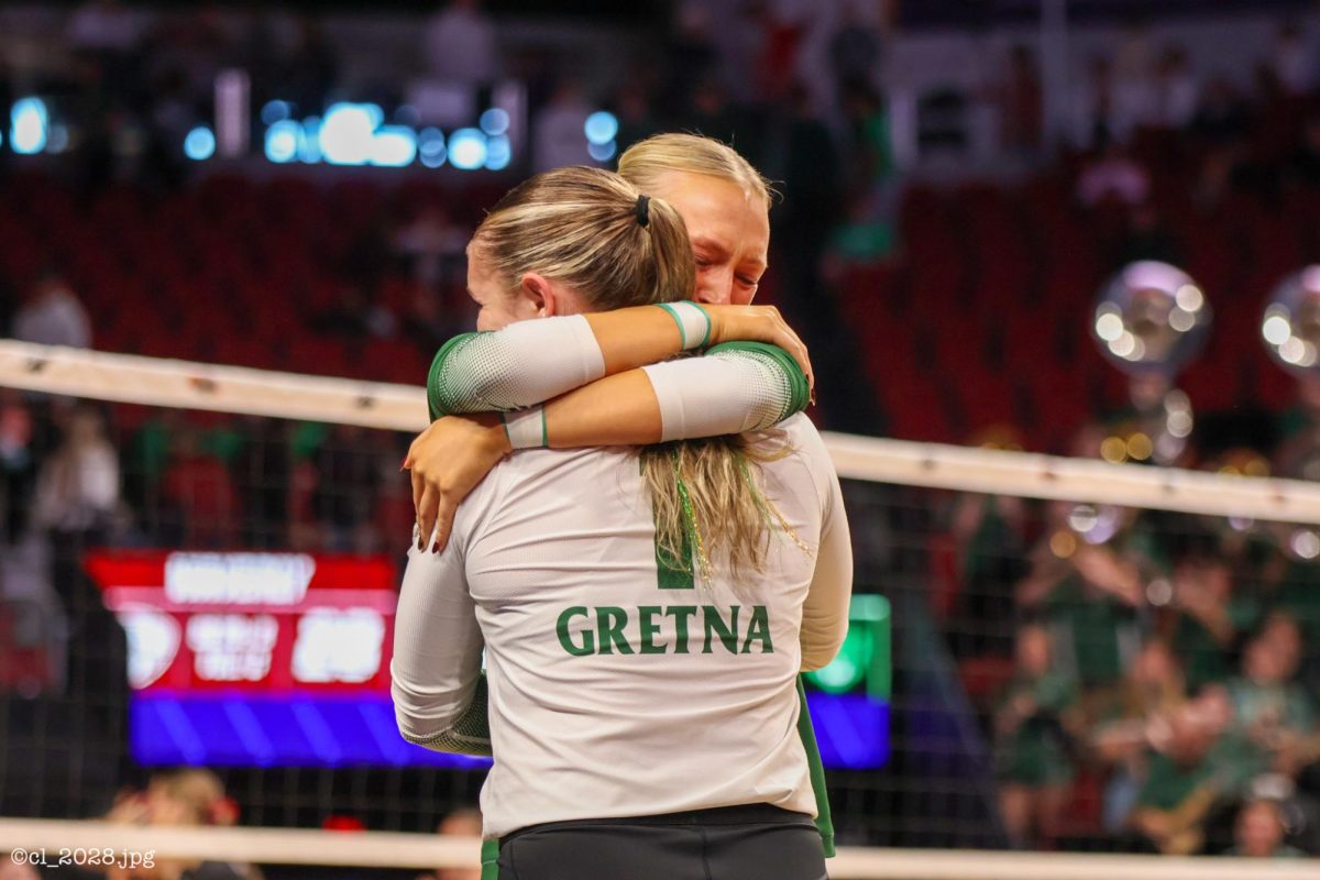Seniors Halle Mason and Lily Zimmerman embrace after a tough three-set loss to Waverly in the State Quarterfinal. This was their final game of their four-year high school careers. 