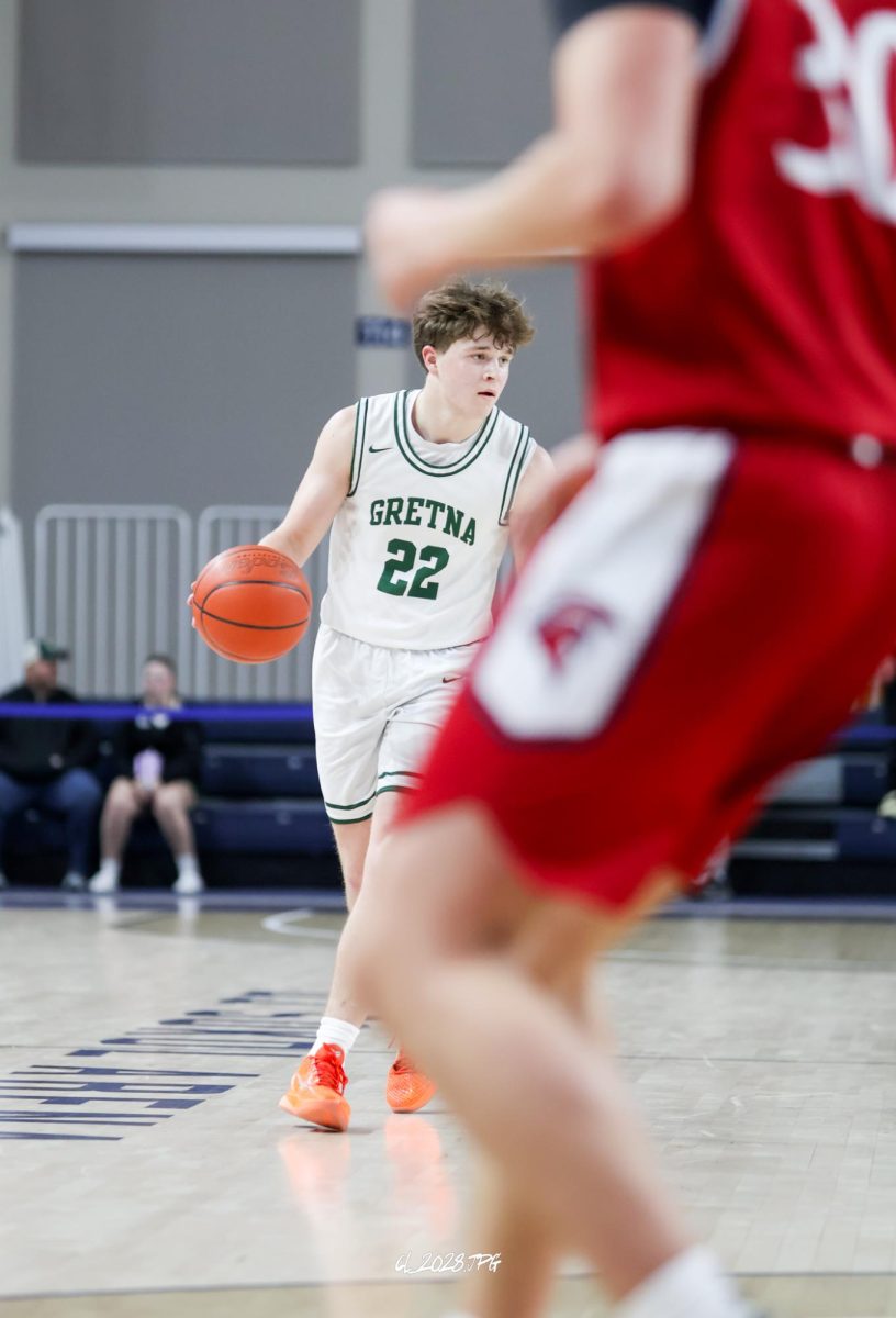 Junior Griffin Snyder brings the ball down the floor to reset the pace. The Dragons slow pace of play allowed them to crawl back and make it a four-point lead at half.