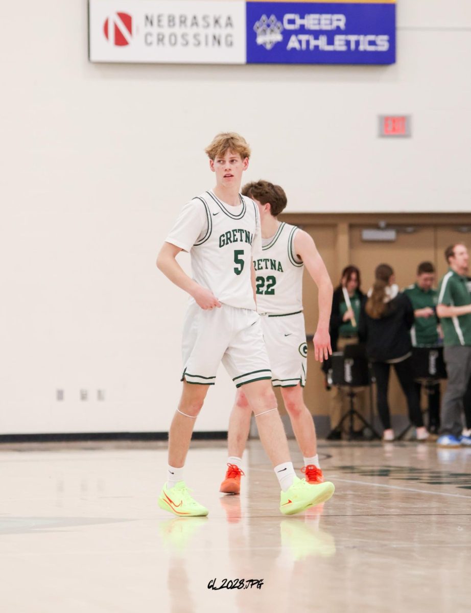 Junior Lucas Hack walks onto the court after the halftime break. The Dragons ended first half down and they were looking to regroup and comeback vs. Mount Michael.