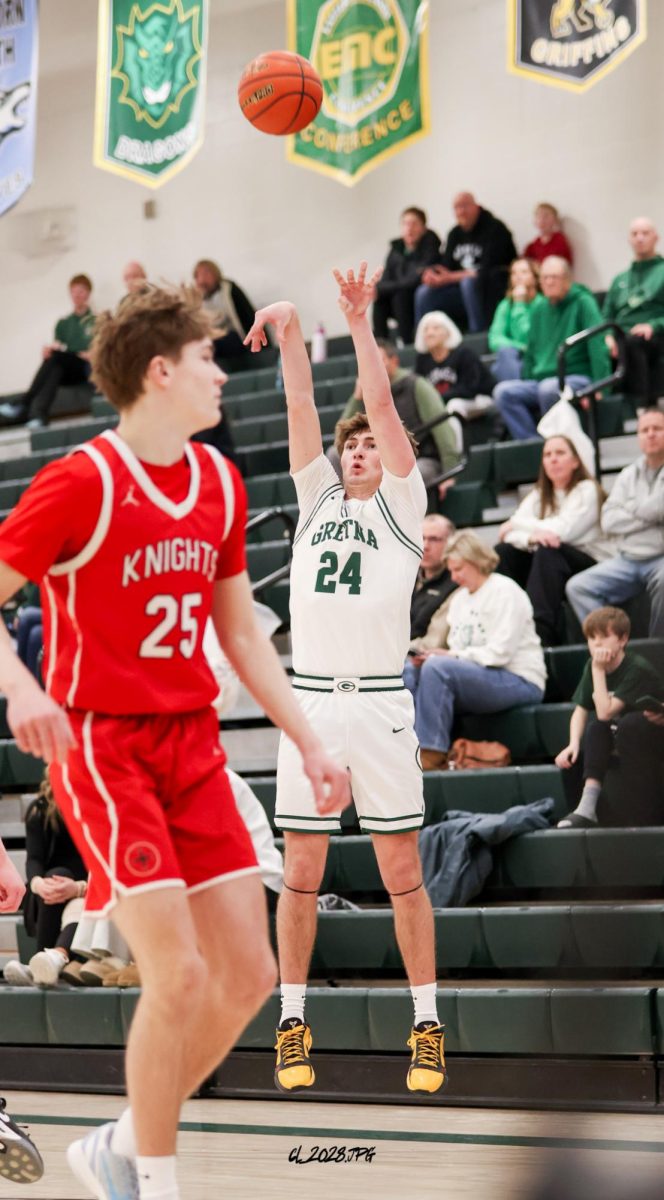 Senior Treven Wilkens shoots a three pointer to extend their lead on their second half comeback. The Dragons rattle off a 20 point fourth quarter to beat Mount Michael.
