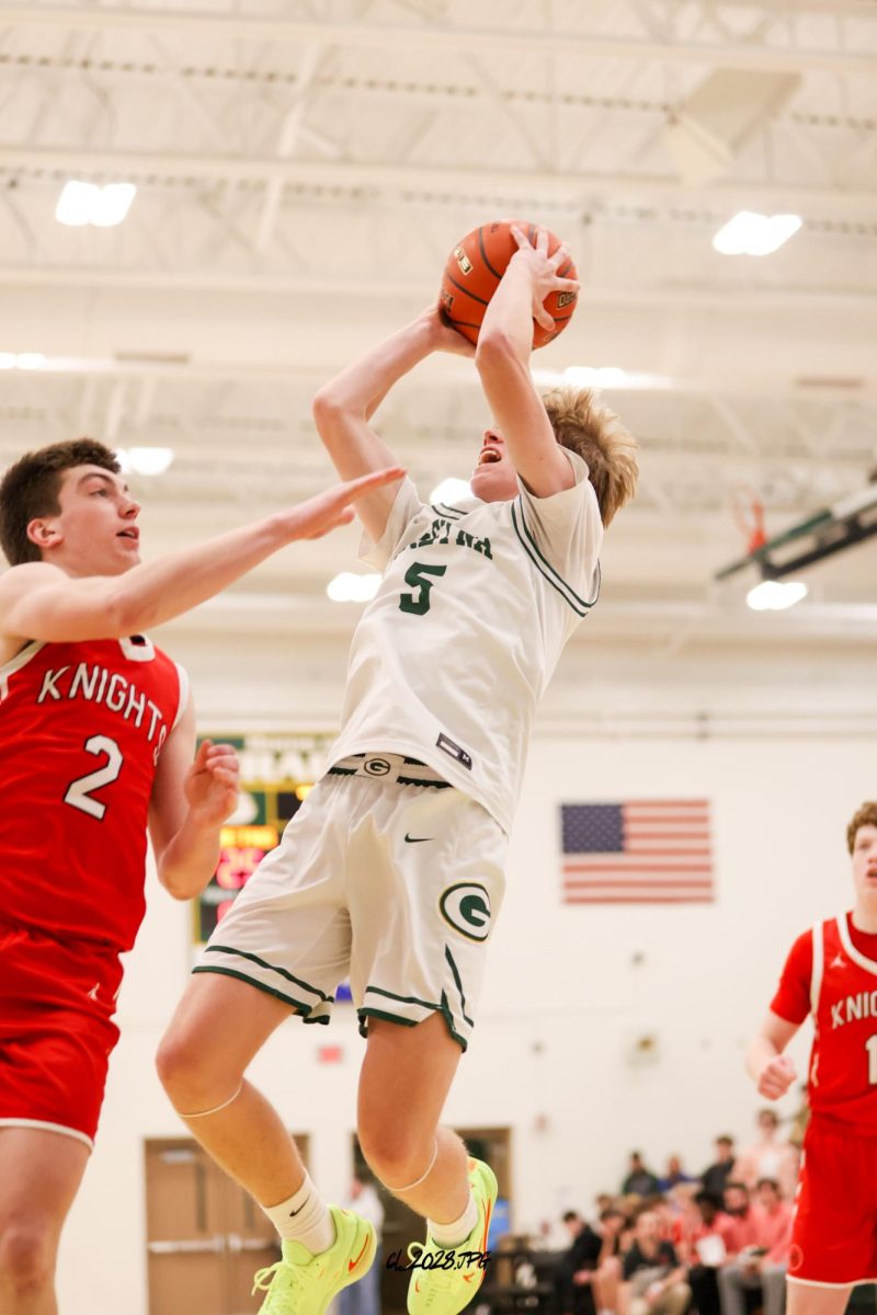 Junior Lucas Hack drives to the basket and steps back and puts up a fade away shot. Hack has been one of Gretna's leader in points all season.
