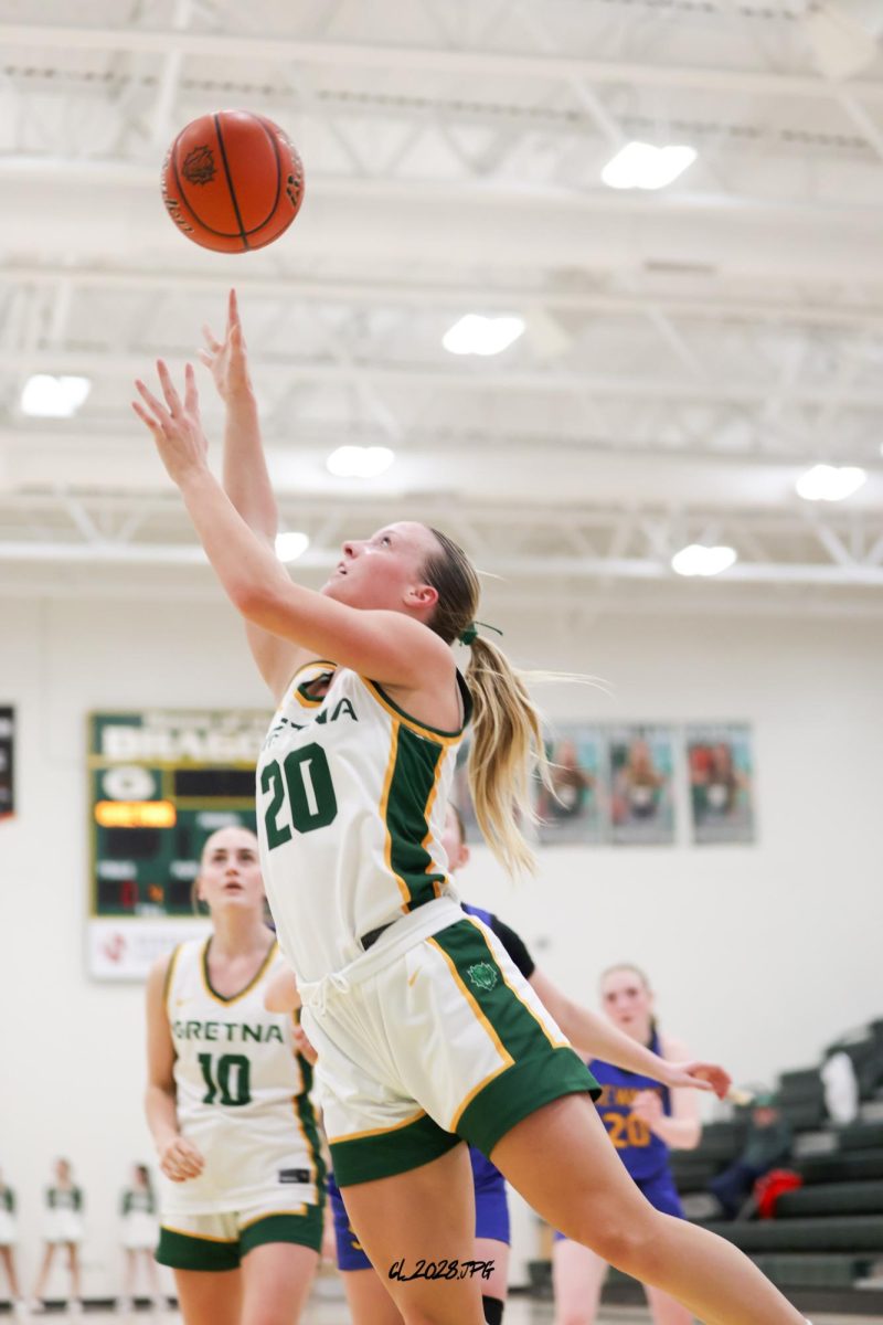 Senior Maggie Miller drives to rim and lays it up for the two points. Miller has been one for the Dragons premiere scorers all season.