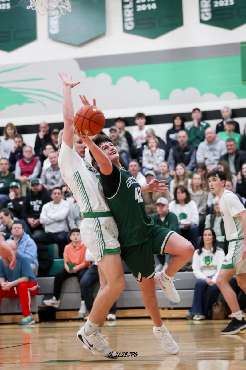 Senior Michael Knudsen twist and turns his way for a lay up.