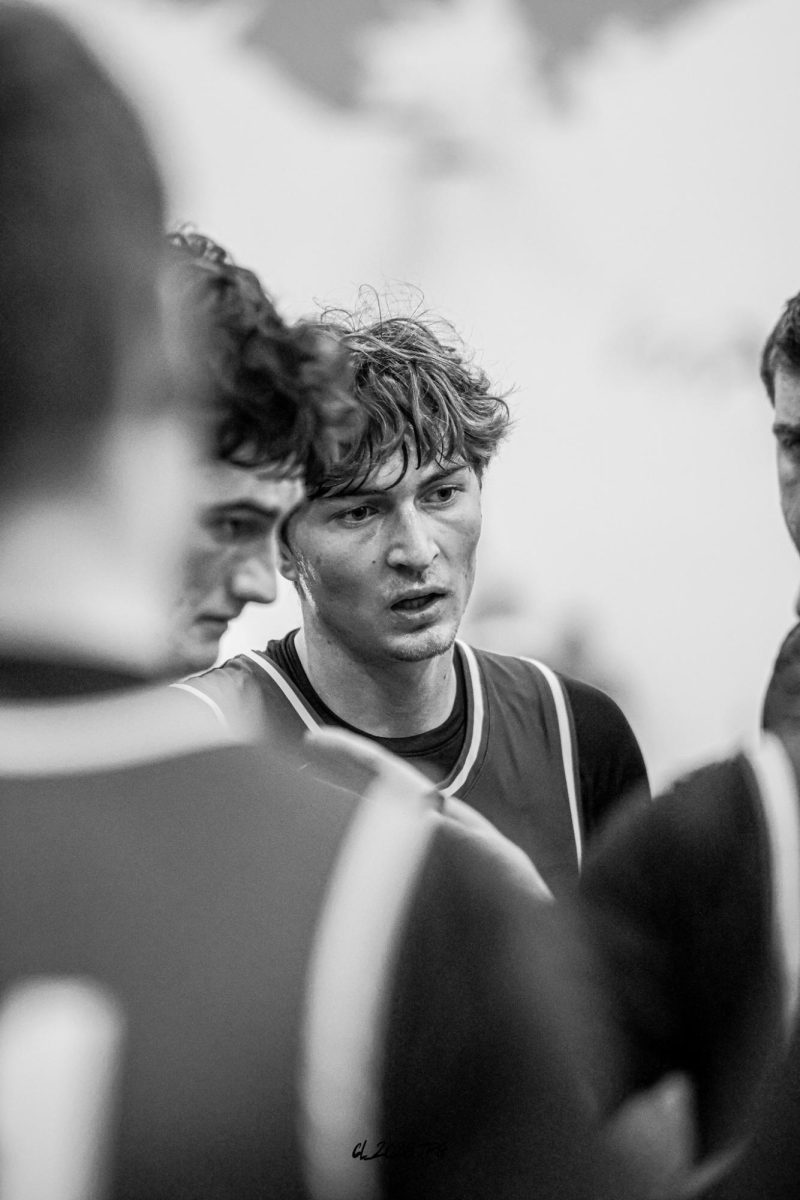 Senior Treven Wilkens stands in the Gretna huddle as the Dragons design plays toward the end of their game vs. Skutt Catholic.