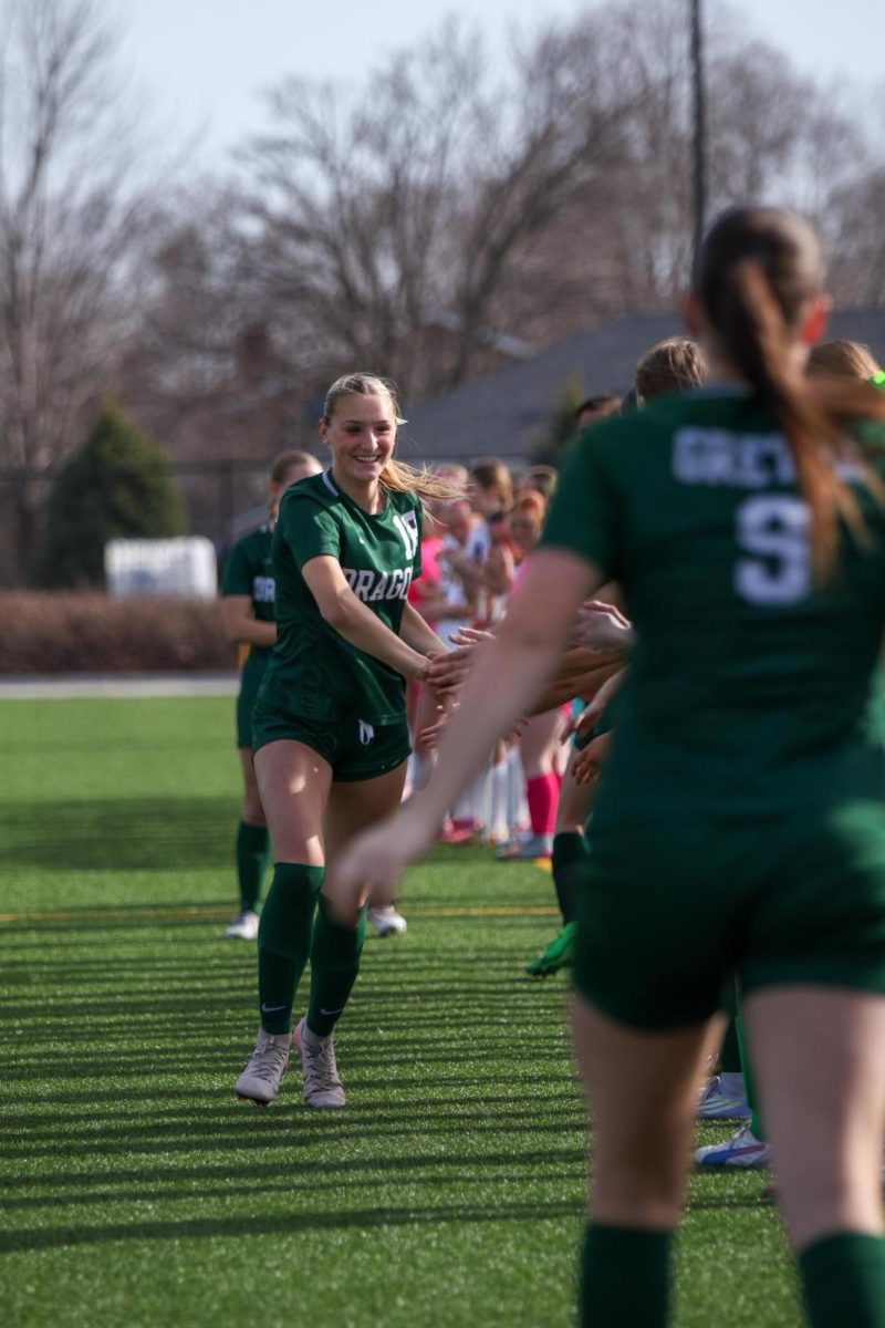 Sophomore Aspen Votruba high fives her teammates prior to the start of the game against Gretna East.  The Griffins defeated GHS 2-0. 