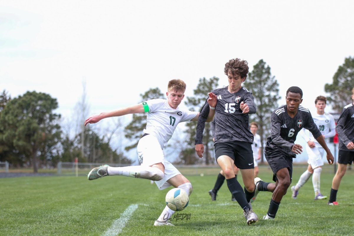 Junior Alex Sowinski fights to kick the ball towards a swarm of Gretna Players positioned at Mount Michael's goal. 