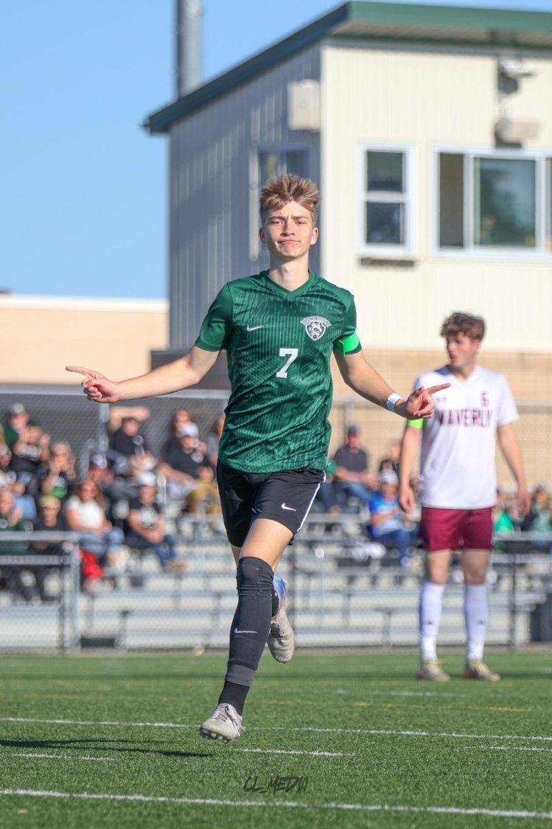 Senior Elijah Fulton celebrates a goal against Waverly. The Dragons opened the flood gates of scoring just two minutes in to the contest.