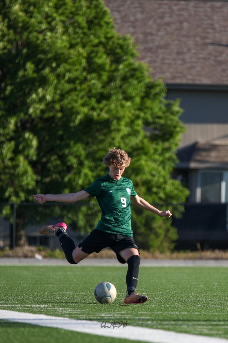 Sophomore Noah Fulton kicks the ball from midfield to set up a Gretna offensive pocession.